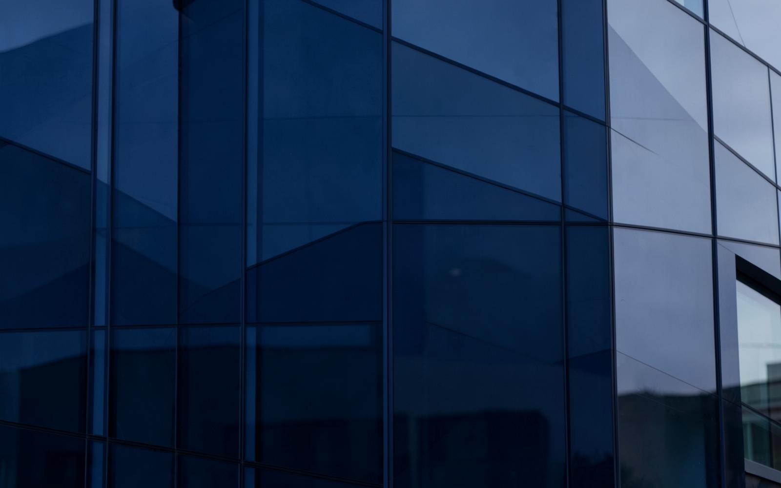 Modern glass architecture in deep navy tones